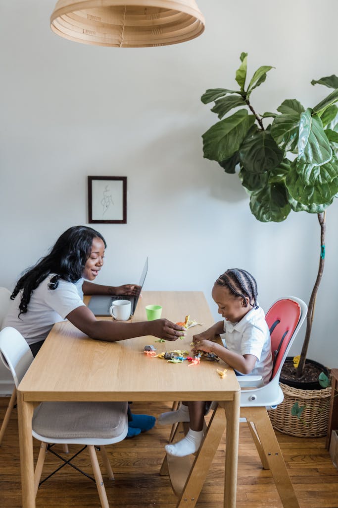 A mother and child enjoying leisure time together at a kitchen table, playing with toys.